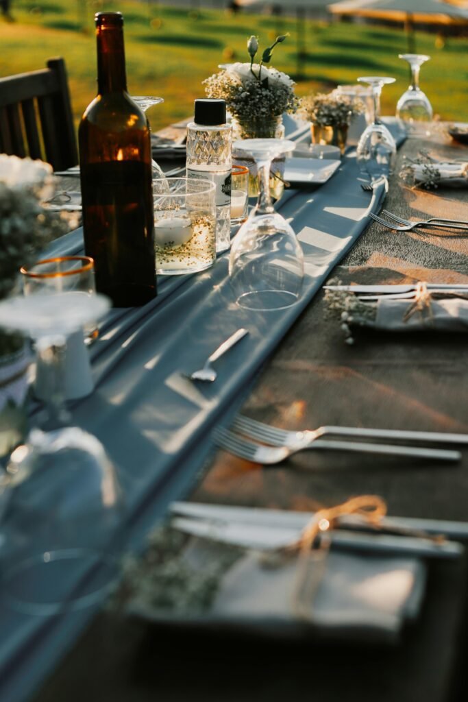 Charming outdoor dinner table with elegant tableware and floral decorations, perfect for celebrations.